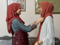 Smiling women preparing for Ramadan celebration at home