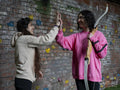 Young women doing high five during archery training