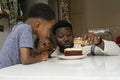 Father and children preparing birthday cake