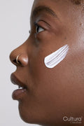 Profile of woman with face cream on cheek