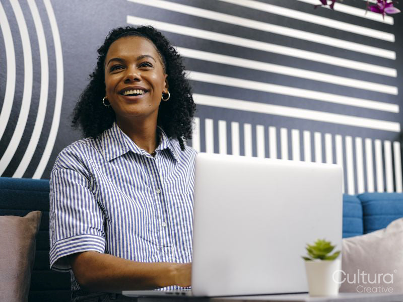 Woman using laptop in office lounge area