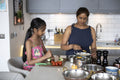 Mother and daughter cooking in kitchen