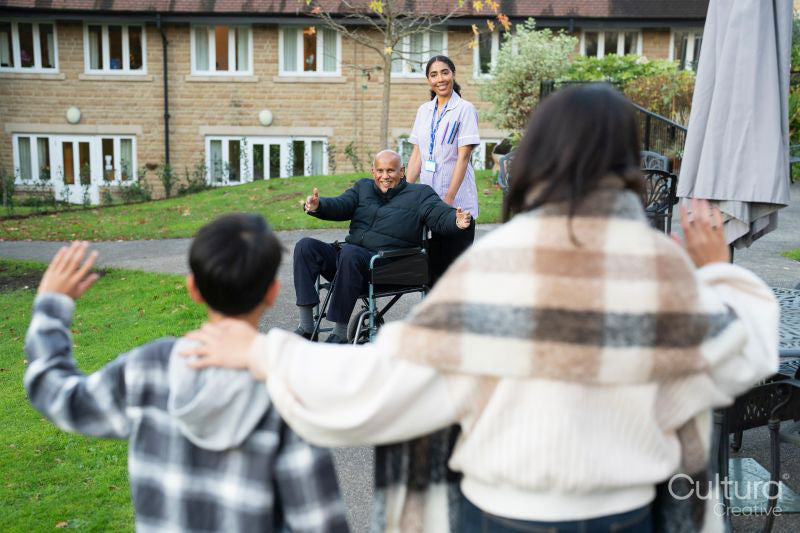 Family visiting senior man at nursing home
