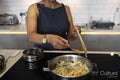 Midsection of woman cooking in kitchen
