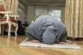 Muslim woman praying at home