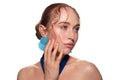Studio portrait of a woman in a blue dress and large blue earrings