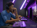 Young man playing video games in gaming club