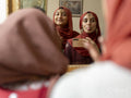 Women photographing their reflection in mirror