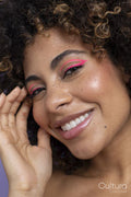 Smiling woman with pink makeup