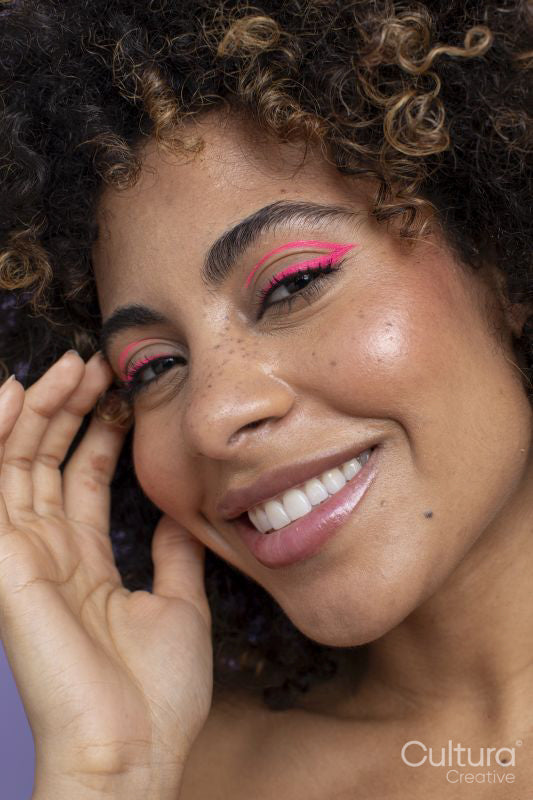 Smiling woman with pink makeup