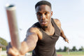 Athlete holding relay baton during race