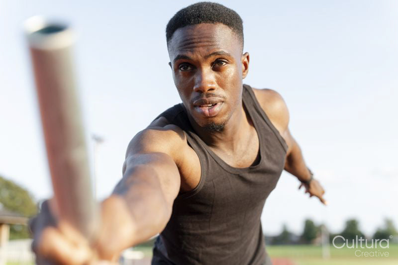 Athlete holding relay baton during race