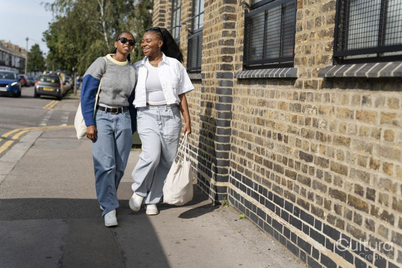 Young female couple walking in street