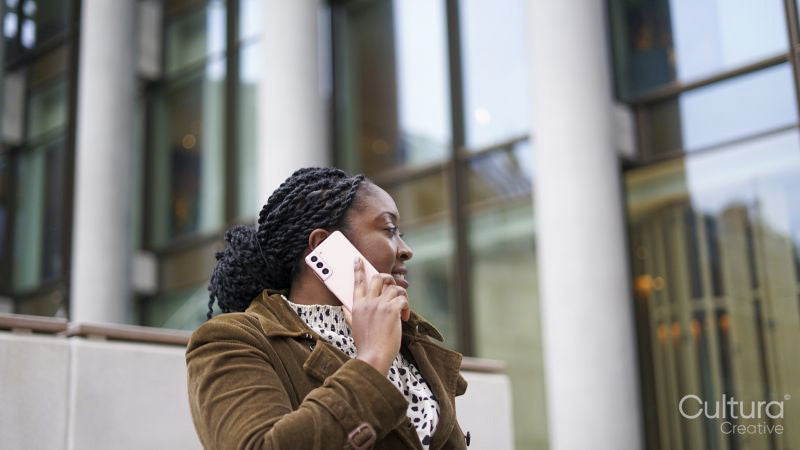 Woman using phone outside office building