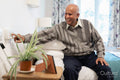 Senior man pushing call button in his room at nursing home