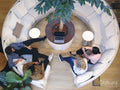 Overhead view of coworkers relaxing in office lobby