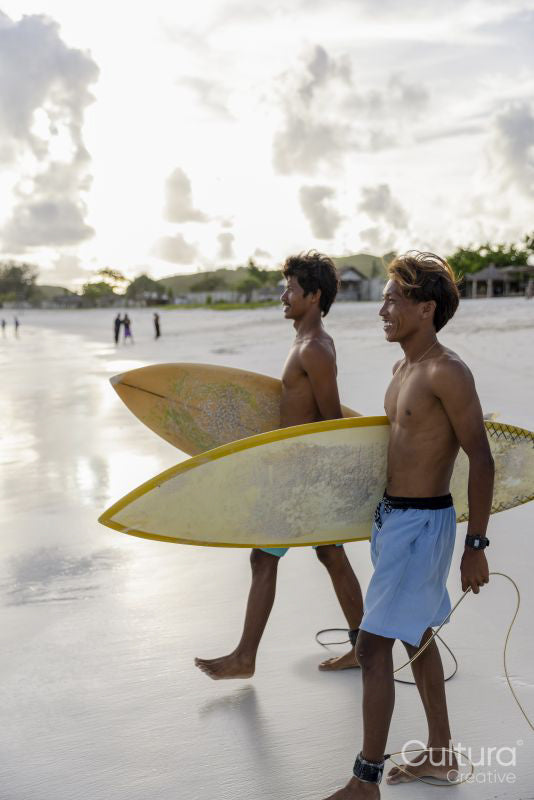 Indonesia, Lombok, Two surfers walking into sea