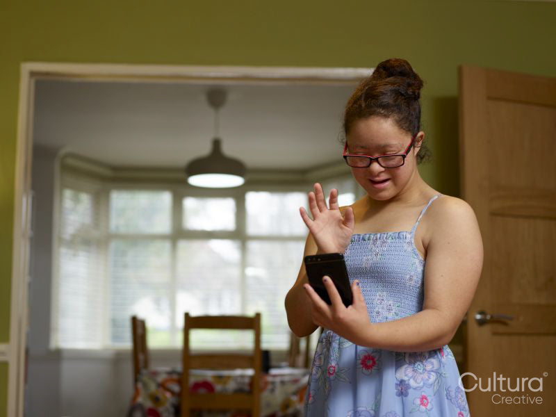 Girl with Down syndrome having video call on phone