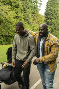 Two smiling men walking in park