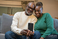 Smiling senior couple having video call on phone