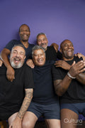 Portrait of smiling men in black t-shirts against purple background