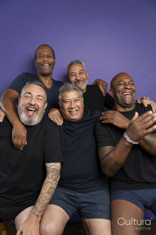 Portrait of smiling men in black t-shirts against purple background