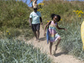 Grandfather and granddaughter going to beach