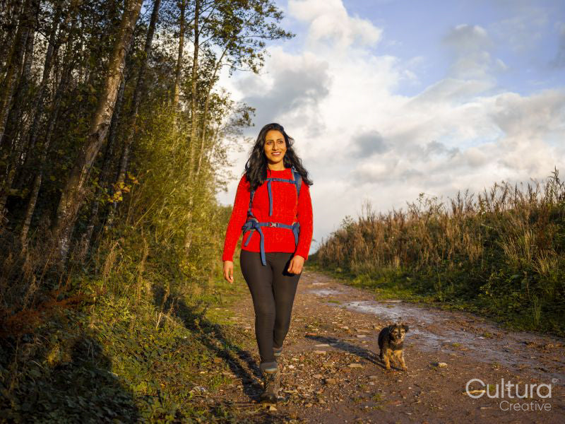 Smiling woman hiking with dog