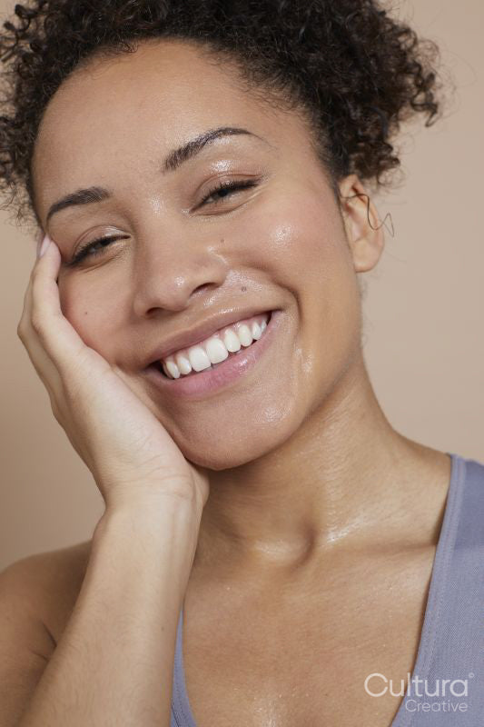 Close-up of smiling athletic woman with sweat of face