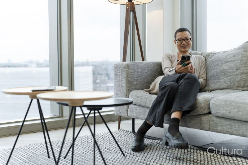 Non binary person resting in office lobby