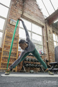 Athletic woman exercising with resistance band at gym