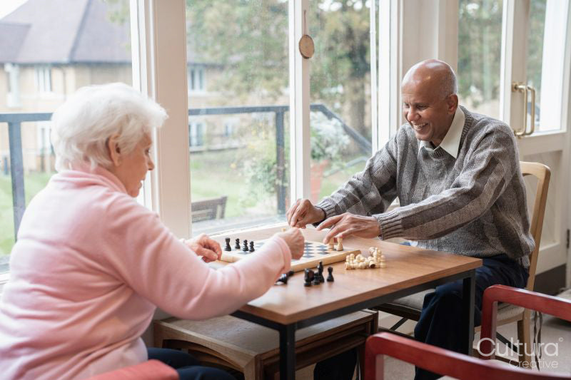 Senior people playing chess in nursing home