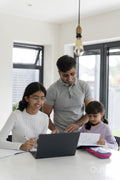 Father helping daughters doing homework