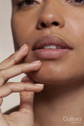 Close-up of young woman touching face