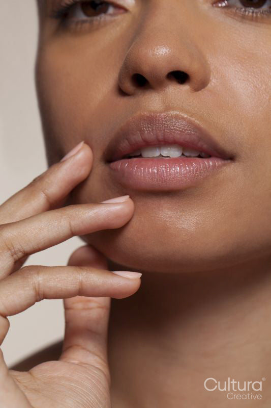 Close-up of young woman touching face