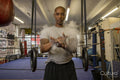 Mature man rubbing hands in gym