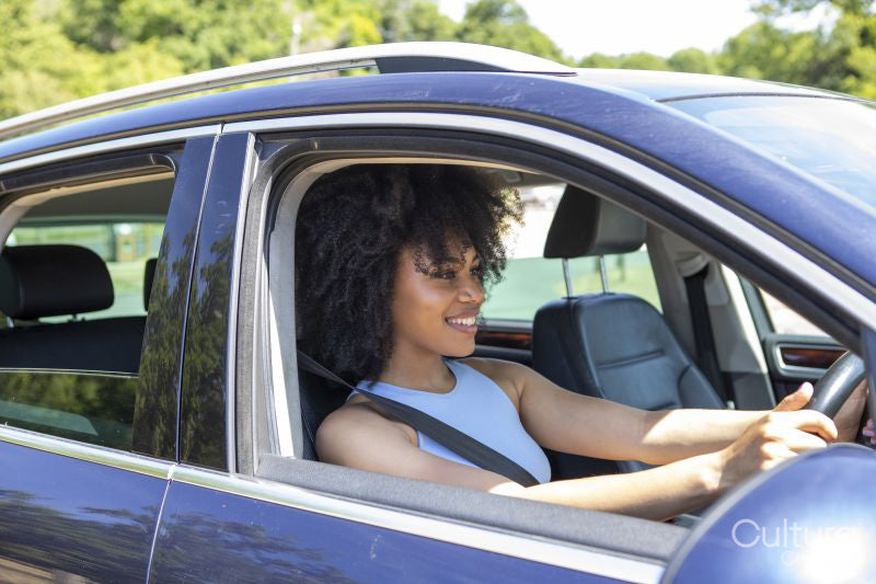 Young woman driving car