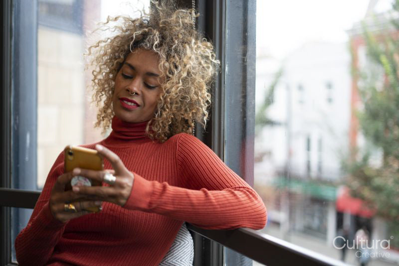 Smiling woman using smart phone