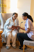 Senior lady showing photography to nurse at nursing home