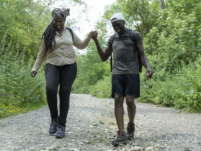 Mature couple holding hands while hiking