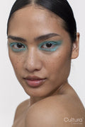 Portrait of woman with black hair and blue makeup