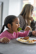 Girl eating dinner with family