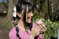 Smiling young woman eating dessert in park