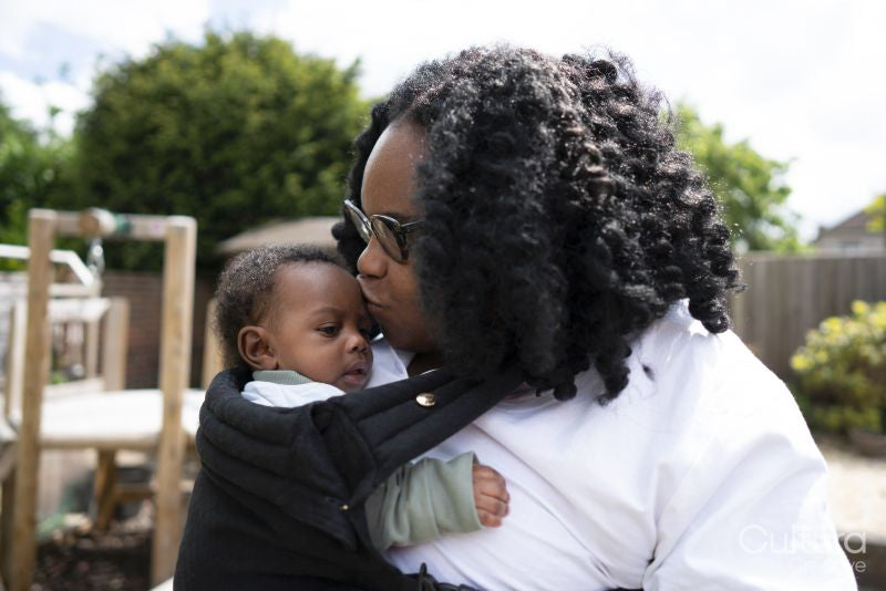 Mother kissing baby son