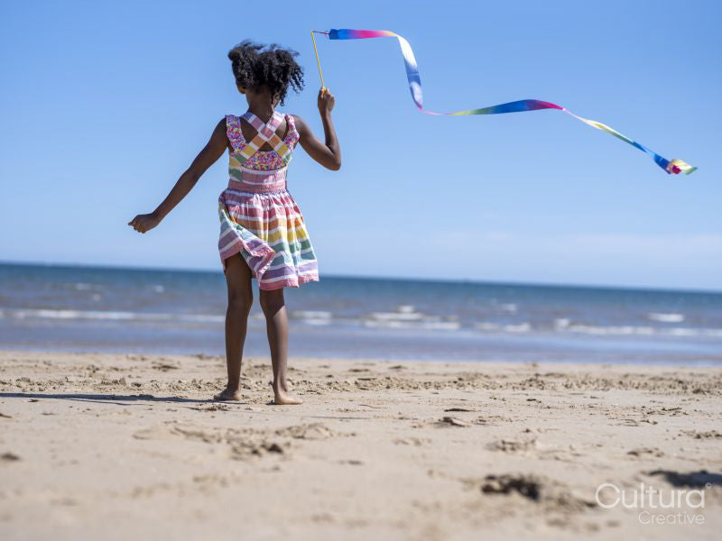 Girl with ballet ribbon on beach