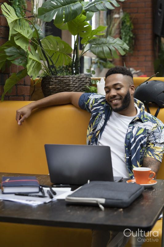 Man sitting in office lounge using laptop