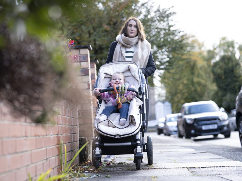 Woman pushing baby in stroller
