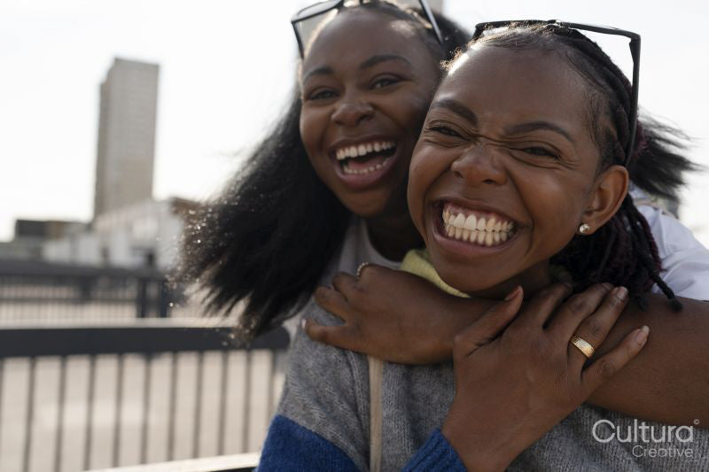 Portrait of smiling young female couple hugging