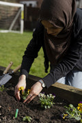 Woman taking care of flowers in garden