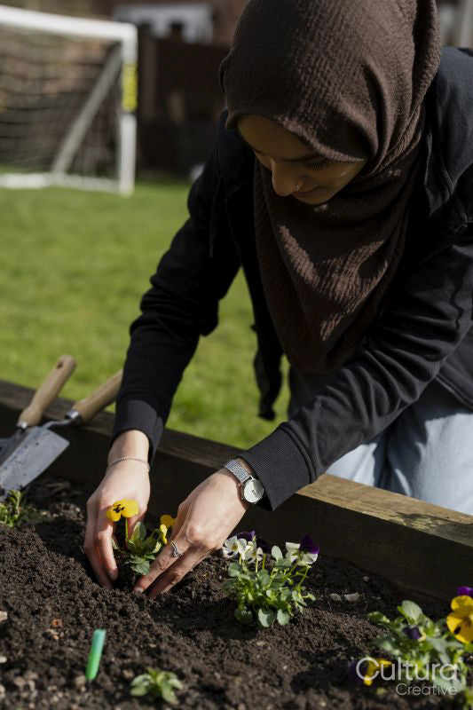 Woman taking care of flowers in garden